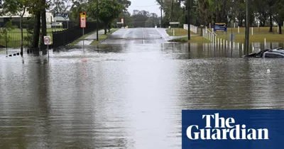 Man found dead in Queensland flood waters as state hit by multiple storms and days-long deluge